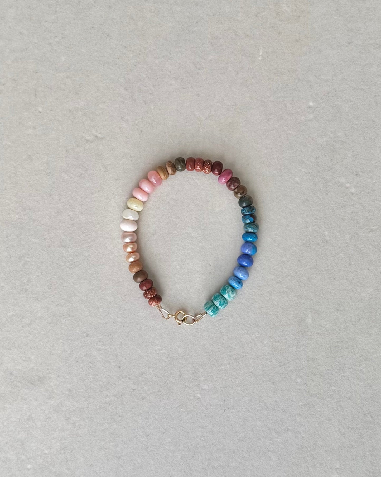 Multicolored beaded bracelet on a light gray background
