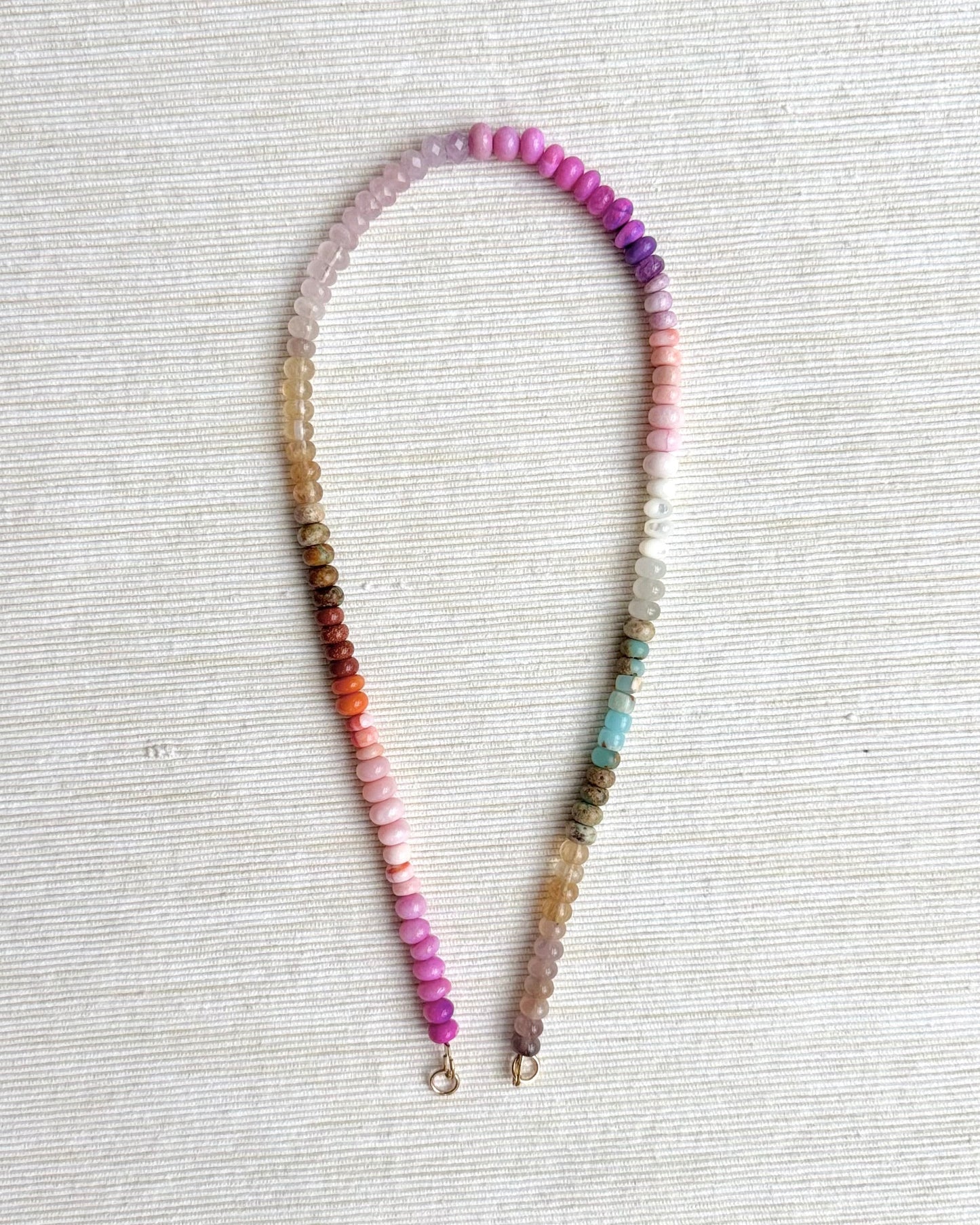 Necklace with multicolored beads on a light gray background