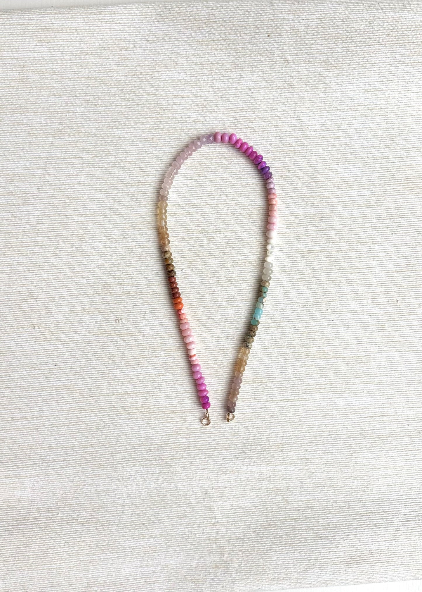 Beaded necklace on a textured white surface