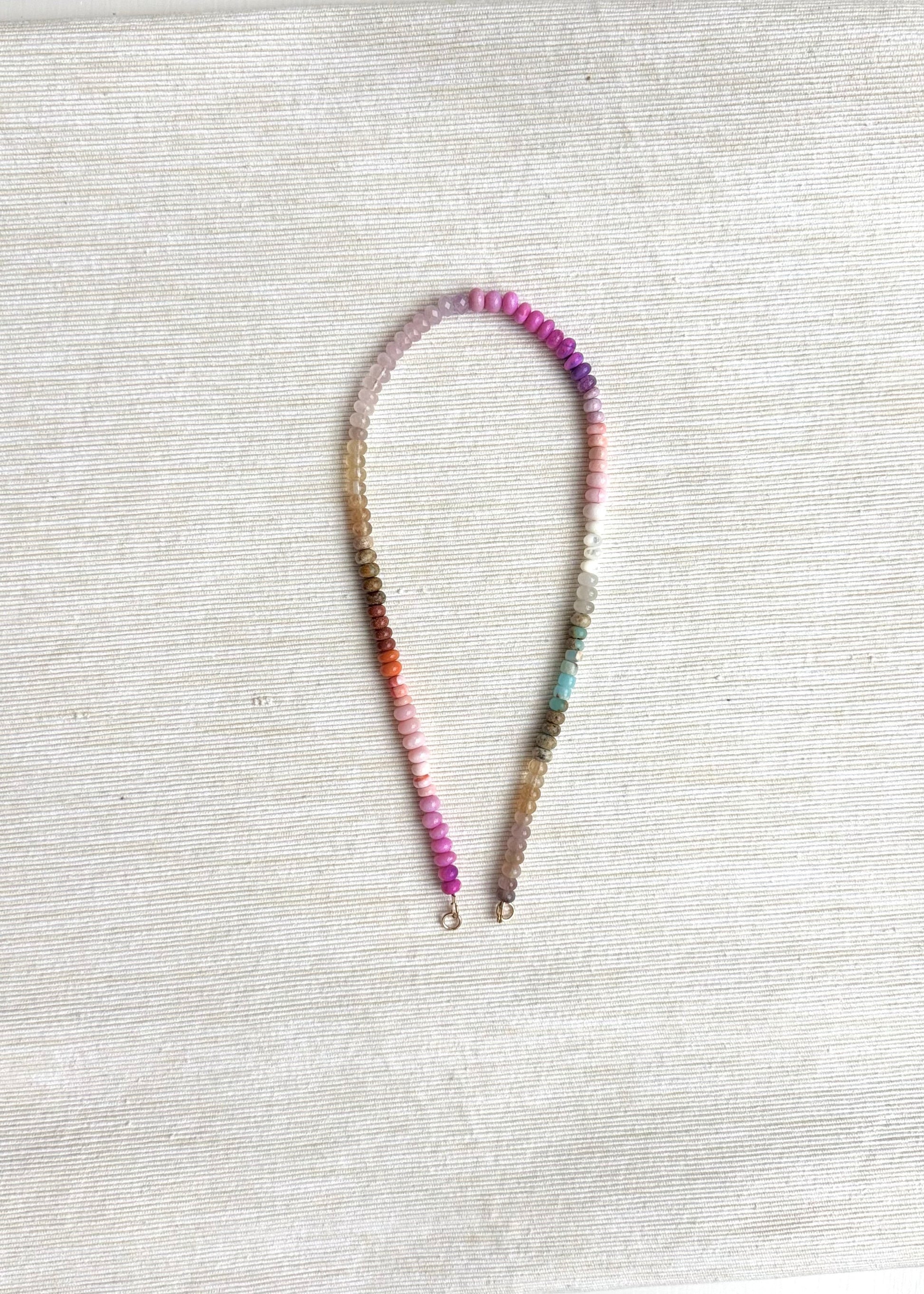 Beaded necklace on a textured white surface