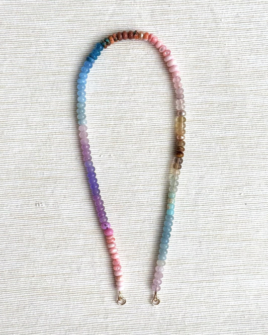 Colorful beaded lanyard on a textured white surface