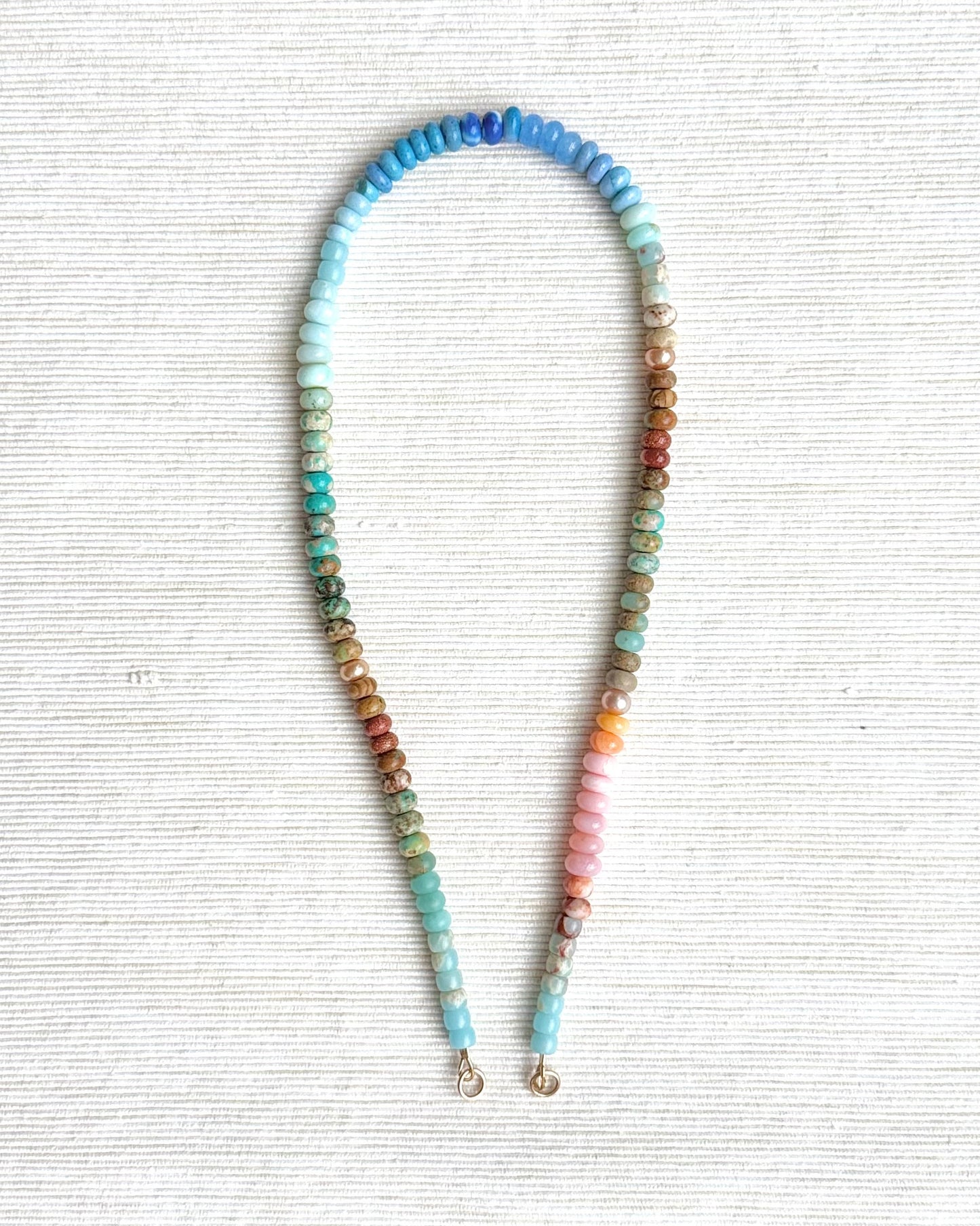 Colorful beaded headband on a textured white background