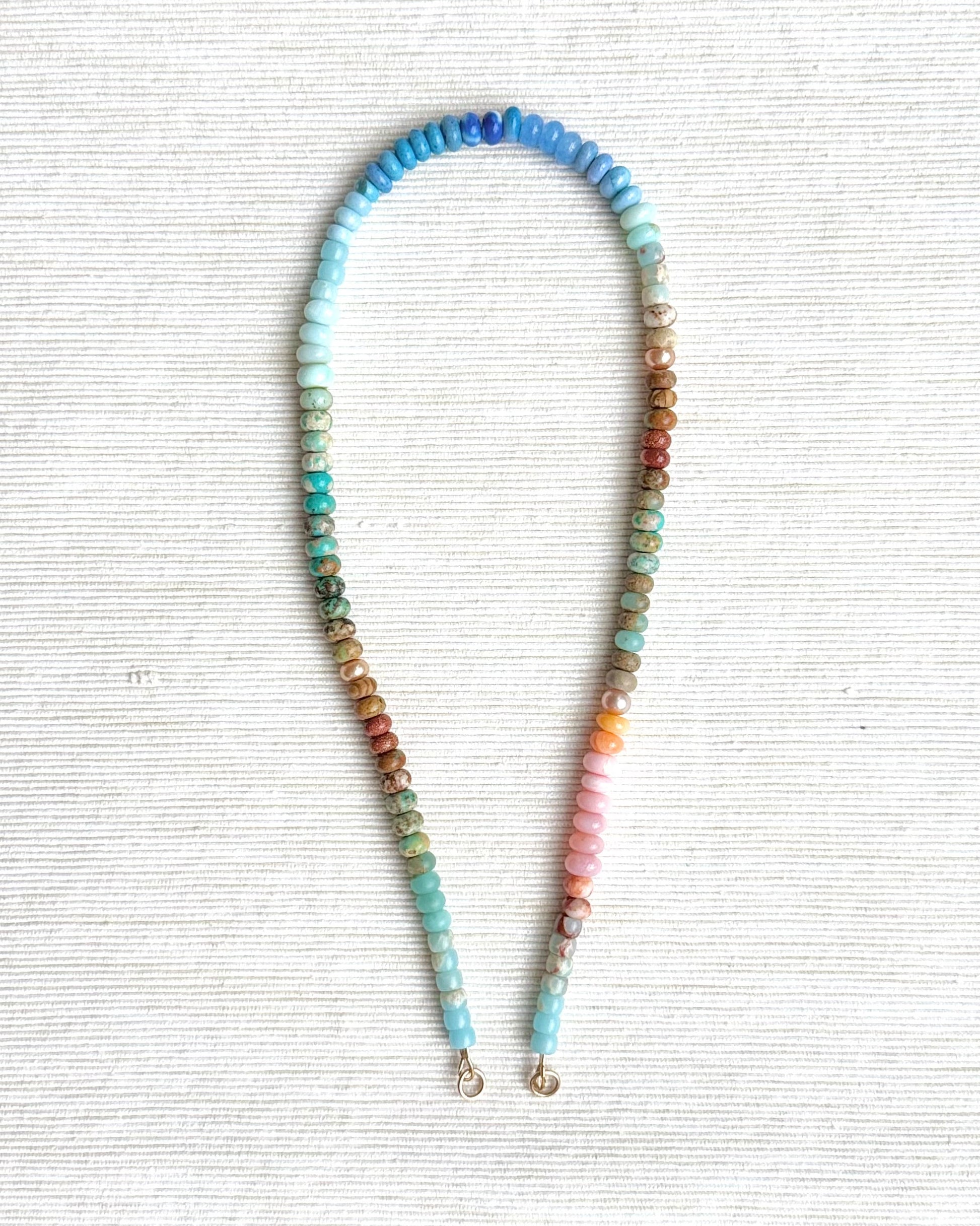 Colorful beaded headband on a textured white background
