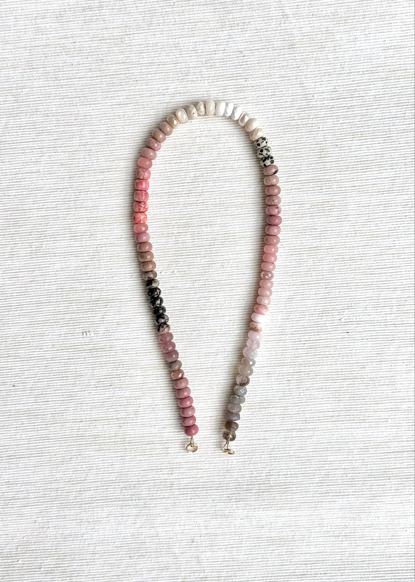 Necklace with multicolored beads on a light gray background