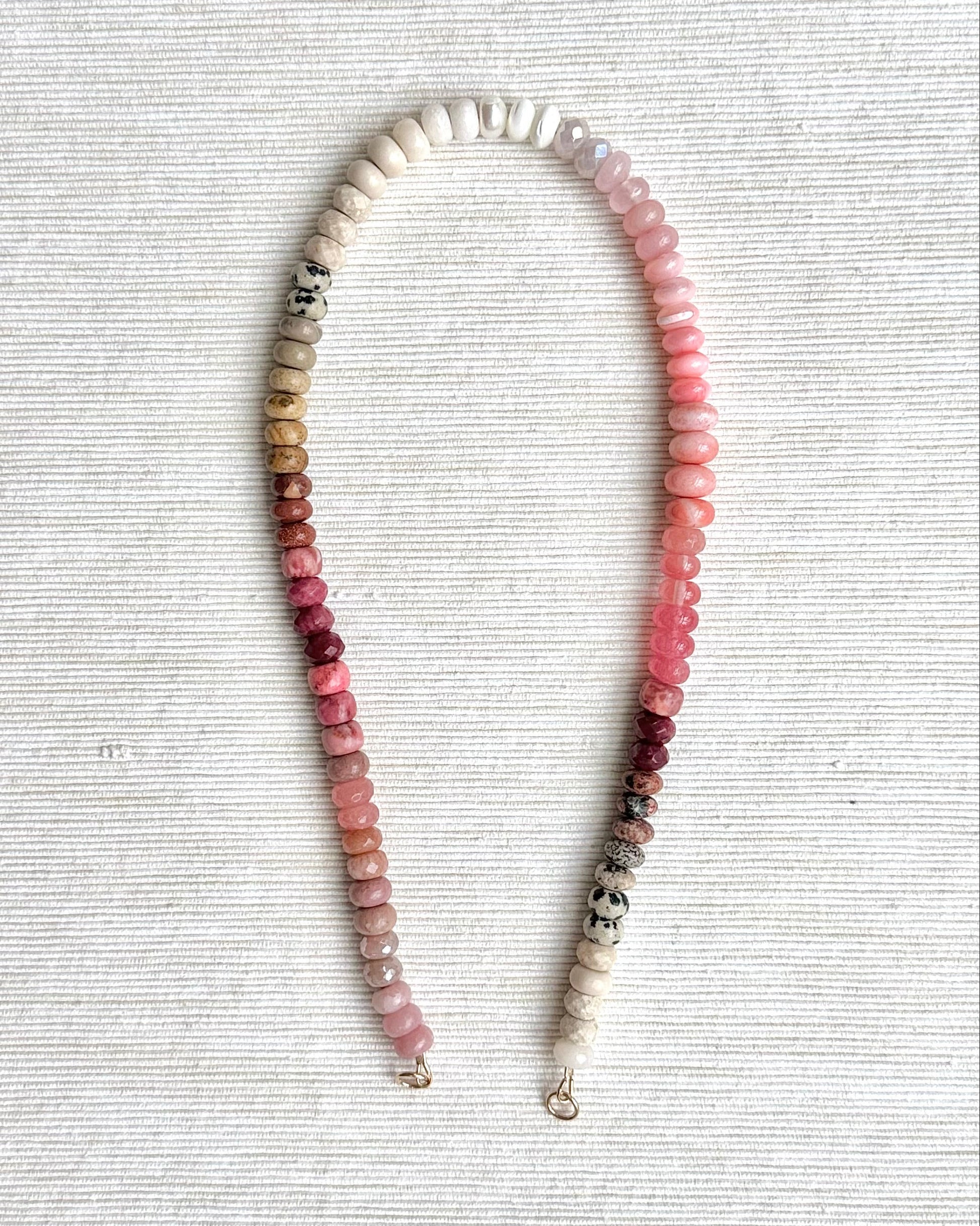 Necklace with multicolored beads on a textured gray surface