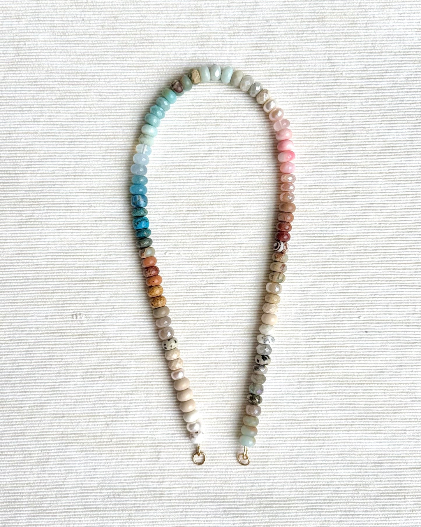 Multicolored beaded necklace on a light gray background