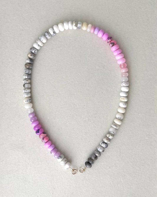 Beaded opal gemstone necklace with multicolored ombre effect beads in a gray frame