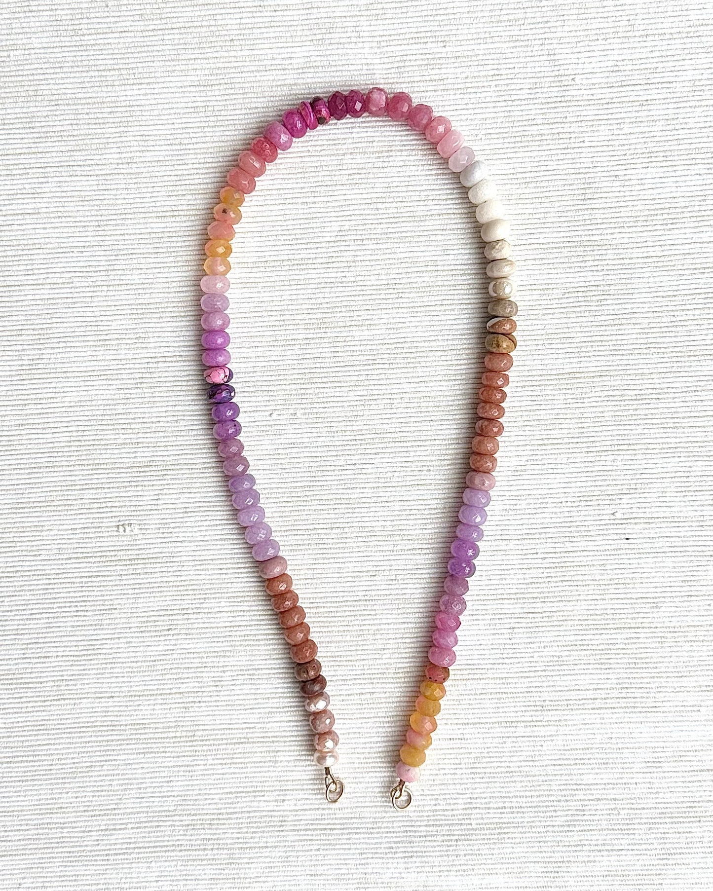 Multicolored beaded necklace on a light gray background
