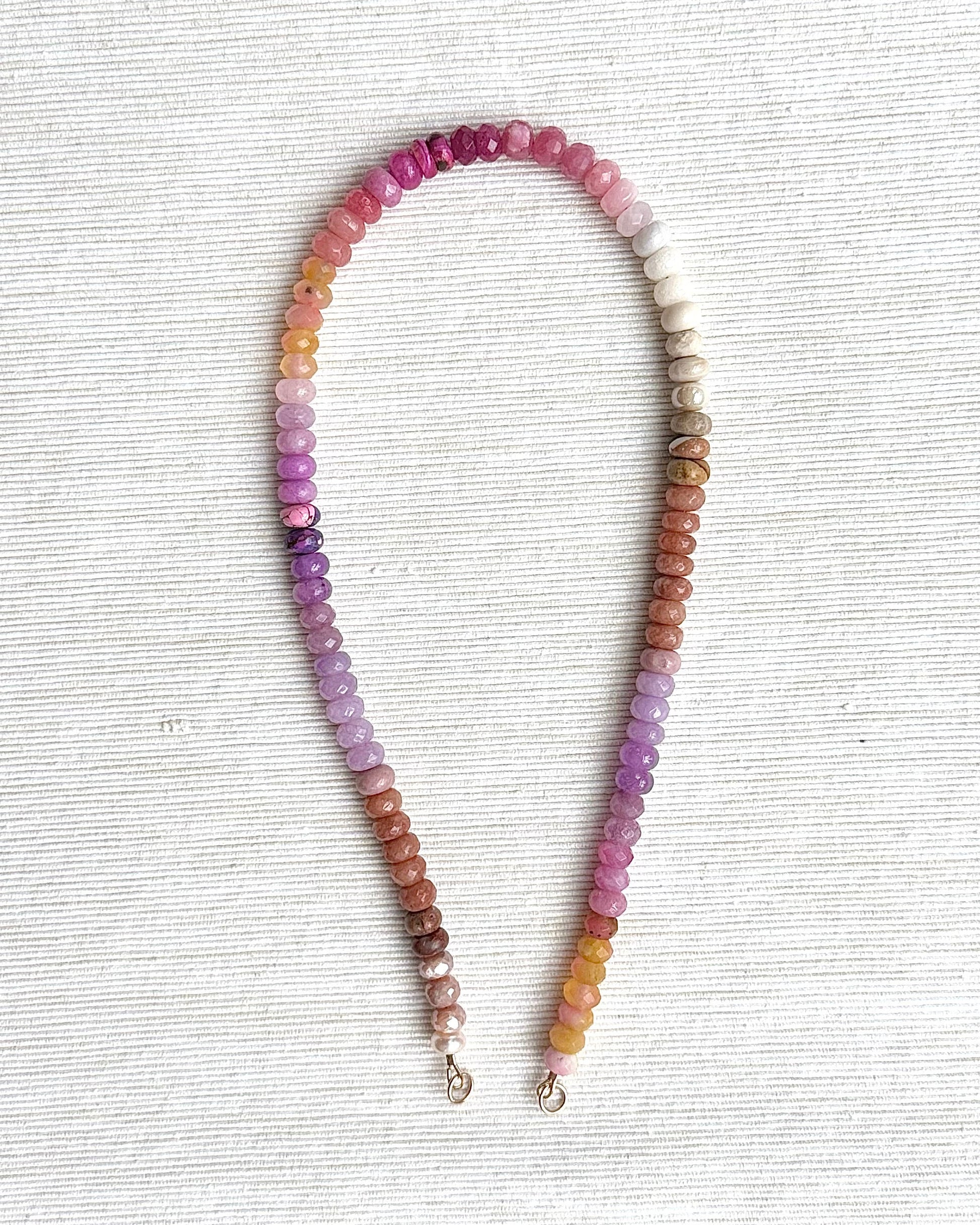 Multicolored beaded necklace on a light gray background
