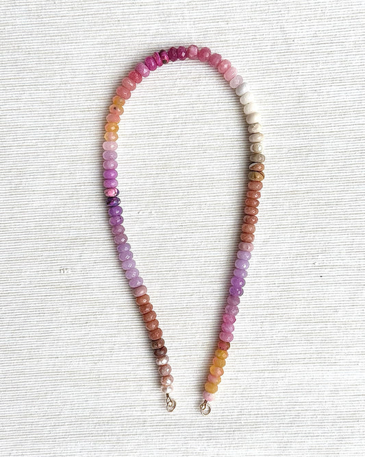 Multicolored beaded necklace on a light gray background
